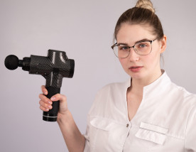 Massage gun being held